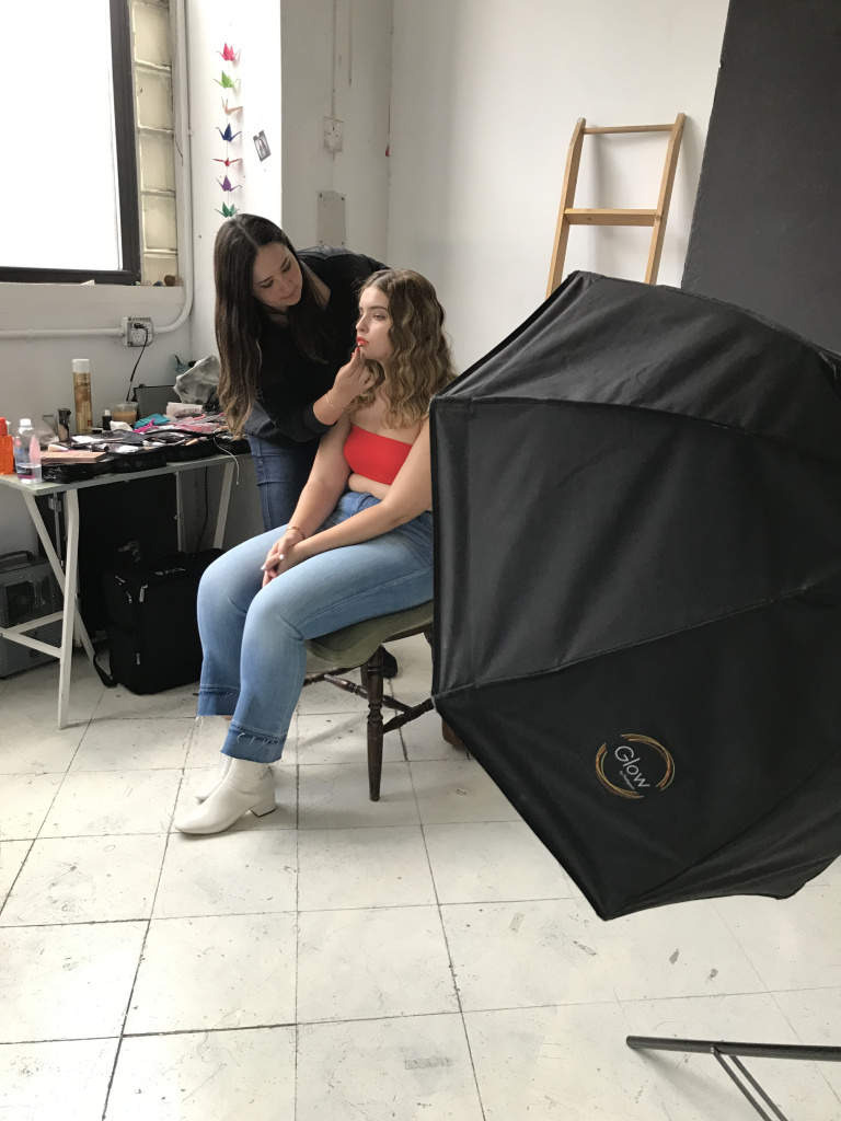 plus size model getting her makeup done for a photo shoot