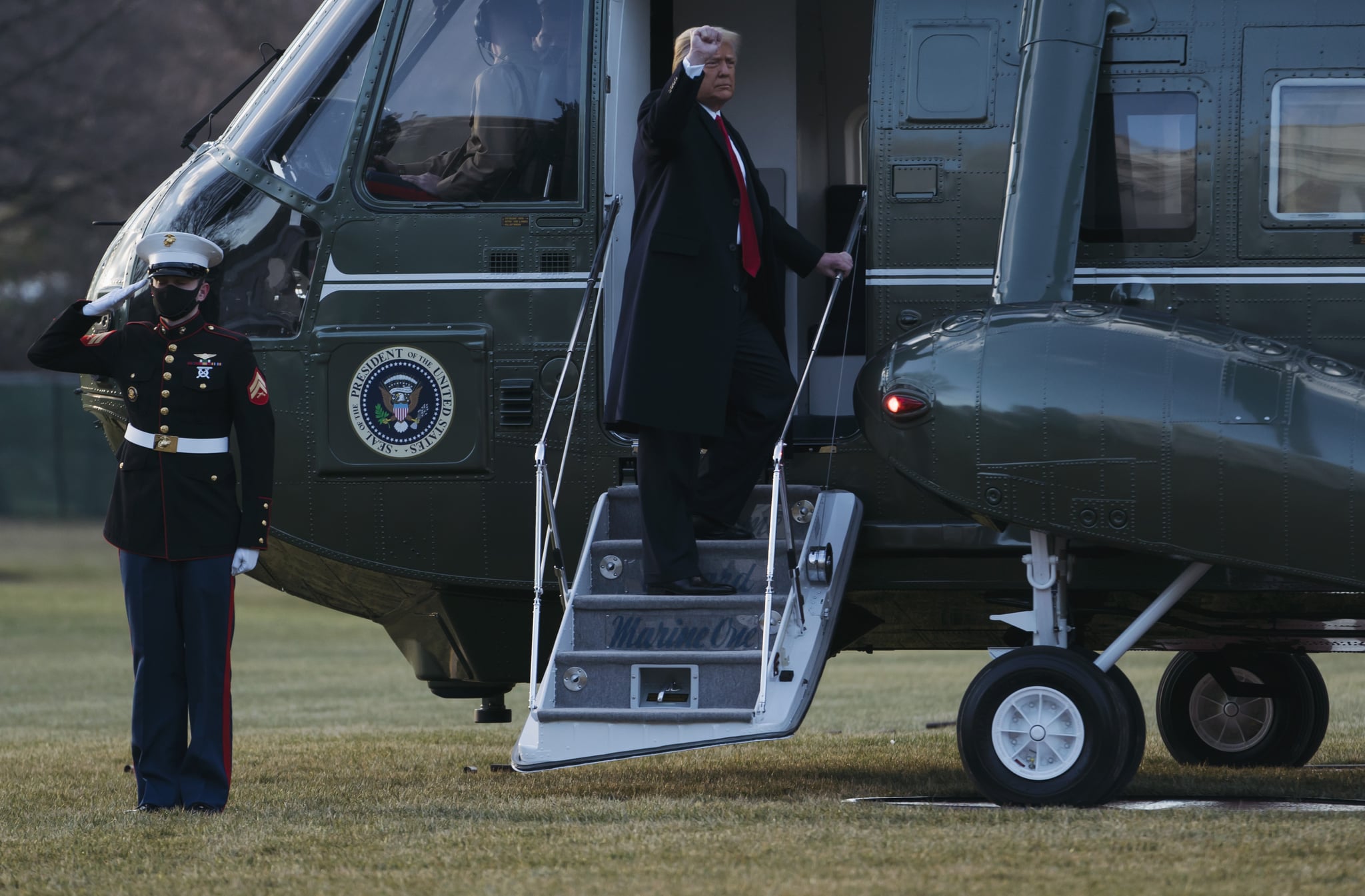 WASHINGTON, DC - JANUARY 20: President Donald Trump and first lady Melania Trump board Marine One as they depart the White House on January 20, 2021 in Washington, DC. President Trump is making his scheduled departure from the White House for Florida, several hours ahead of the inauguration ceremony for his successor Joe Biden, making him the first president in more than 150 years to refuse to attend the inauguration. (Photo by Eric Thayer/Getty Images)