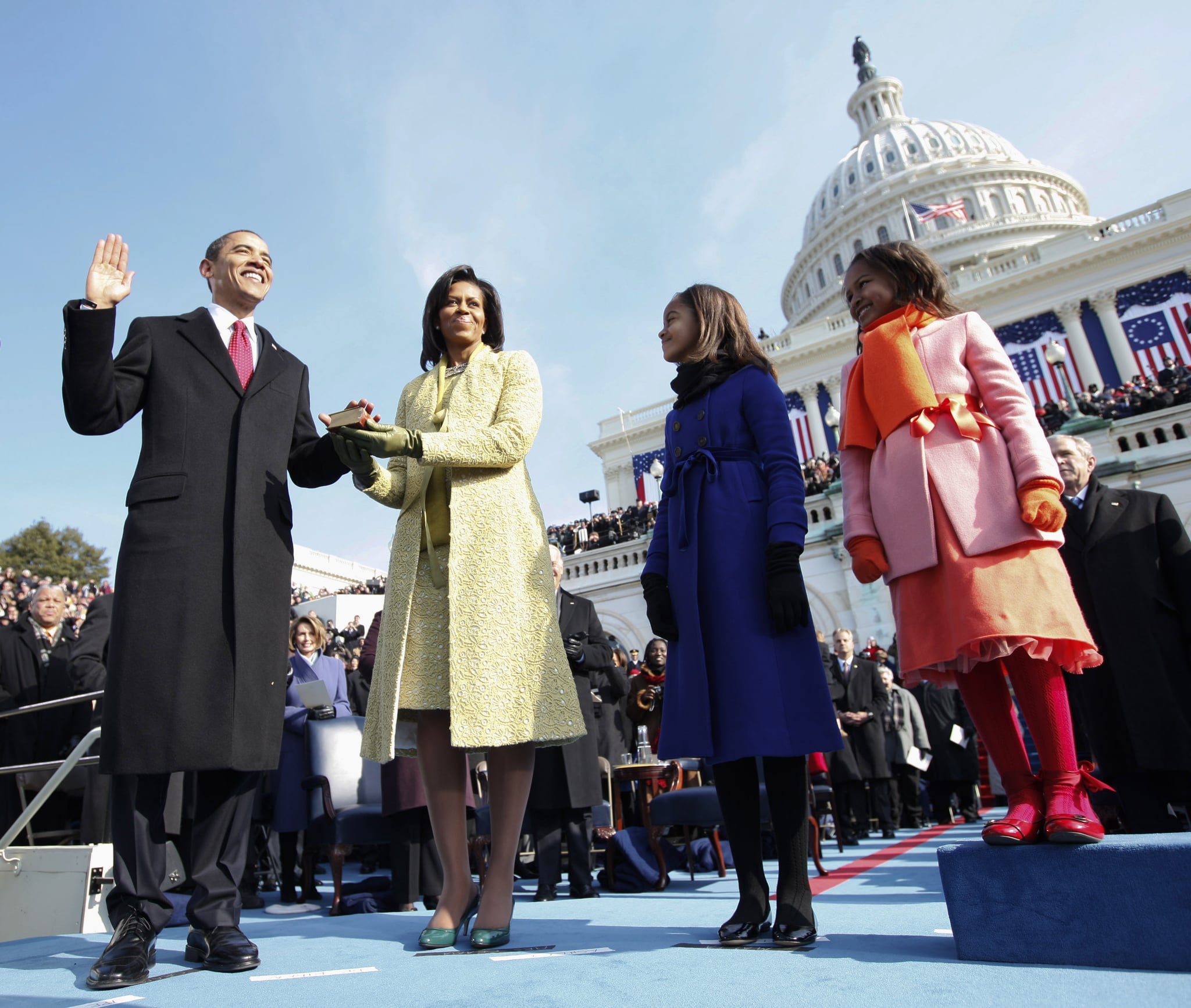 Barack Obama (L) takes the oath of office as the 44th US President with his wife, Michelle, by his side at the US Capitol in Washington, DC, January 20, 2009. The Obama's were joined by their daughters Malia (2ndR) and Sasha. Chuck Kennedy/Pool (Photo credit should read CHUCK KENNEDY/AFP via Getty Images)