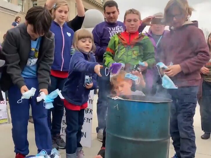 Idaho's #BurnTheMask Rally Sees Kids Tossing Face Masks Into Fire