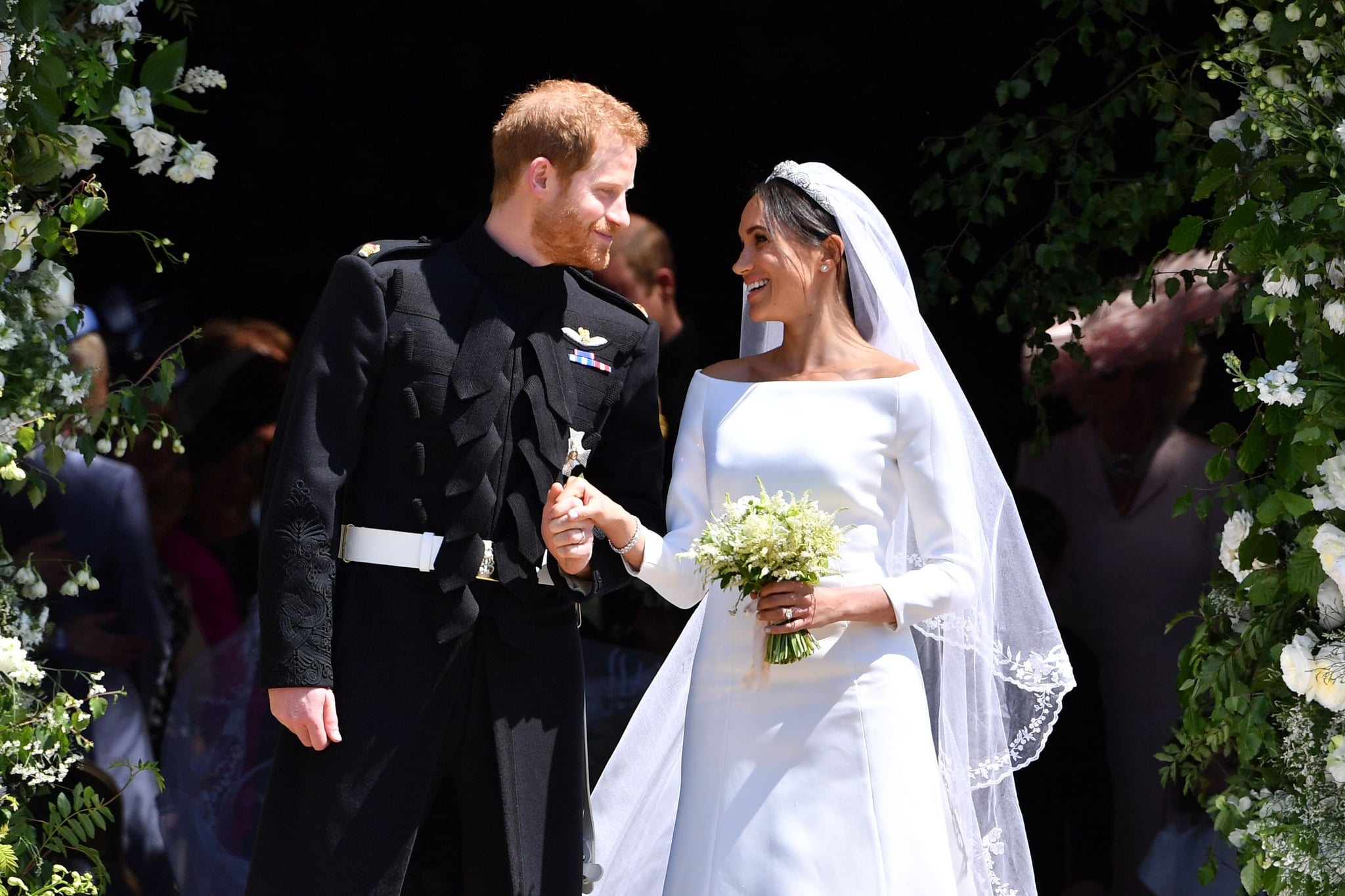 TOPSHOT - Britain's Prince Harry, Duke of Sussex and his wife Meghan, Duchess of Sussex emerge from the West Door of St George's Chapel, Windsor Castle, in Windsor, on May 19, 2018 after their wedding ceremony. (Photo by Ben STANSALL / various sources / AFP)        (Photo credit should read BEN STANSALL/AFP via Getty Images)