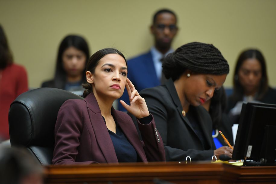 US Congresswoman Alexandria Ocasio-Cortez(D-NY) listens as Michael Cohen, attorney for President Trump, testifies before the House Oversight and Reform Committee in the Rayburn House Office Building on Capitol Hill in Washington, DC on February 27, 2019. (Photo by MANDEL NGAN / AFP)        (Photo credit should read MANDEL NGAN/AFP/Getty Images)
