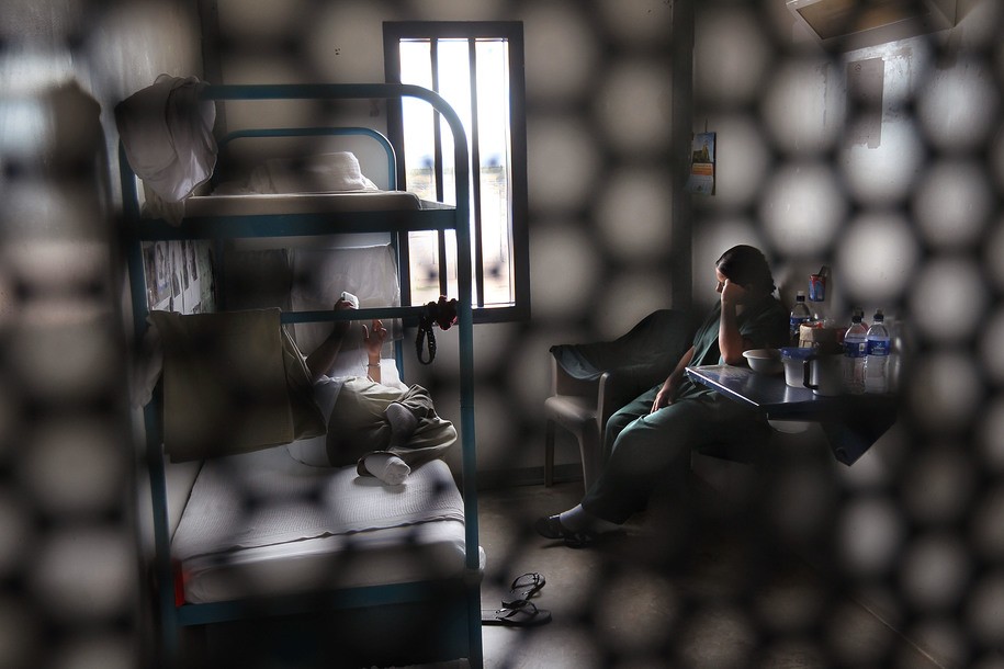 ELOY, AZ - JULY 30:  Immigrants sit in their housing cell in the women