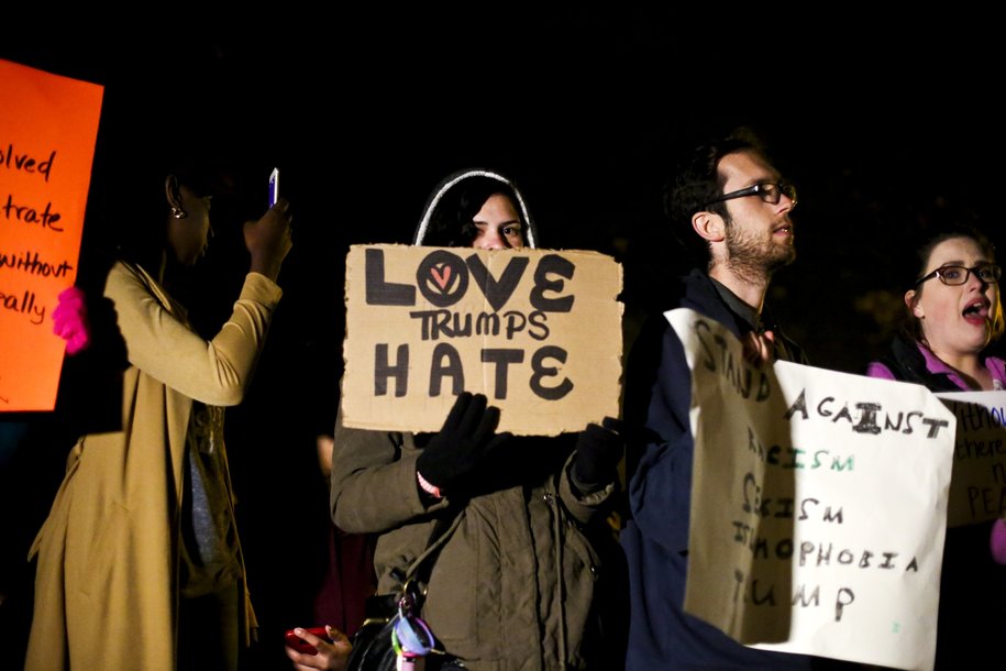 People attend a Kalamazoo Against Hate rally in Bronson Park on Tuesday, Nov. 15, 2016, in Kalamazoo, Mich. Several hundred people came together for the rally, which called for the community to come together and stand up against discrimination and hatred following the presidential election. (Chelsea Purgahn/Kalamazoo Gazette-MLive Media Group via AP)