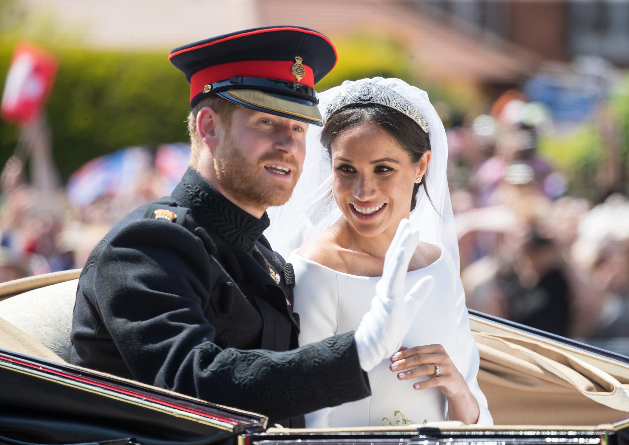 WINDSOR, ENGLAND - MAY 19:  Prince Harry, Duke of Sussex and Meghan, Duchess of Sussex ride by carriage following their wedding at St George