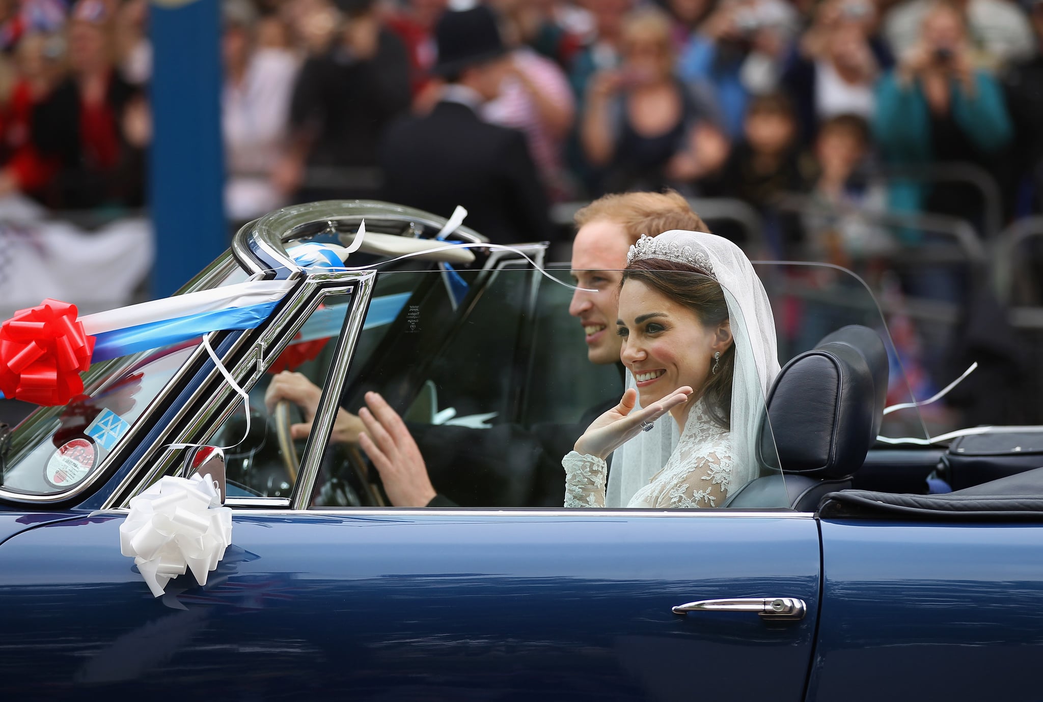LONDON, ENGLAND - APRIL 29:  Prince William, Duke of Cambridge and Catherine, Duchess of Cambridge drive from Buckingham Palace in a decorated sports car on April 29, 2011 in London, England. The marriage of the second in line to the British throne was led by the Archbishop of Canterbury and was attended by 1900 guests, including foreign Royal family members and heads of state. Thousands of well-wishers from around the world have also flocked to London to witness the spectacle and pageantry of the Royal Wedding.    (Photo by Jeff J Mitchell/Getty Images)