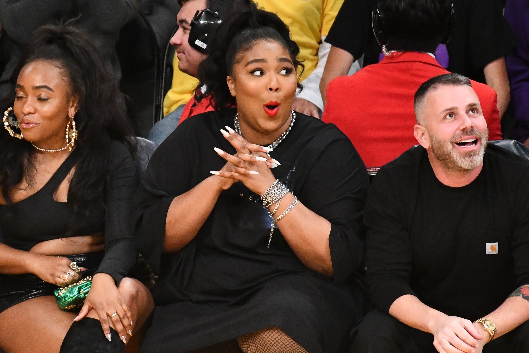 LOS ANGELES, CALIFORNIA - DECEMBER 08: Singer Lizzo (C) attends a basketball game between the Los Angeles Lakers and the Minnesota Timberwolves at Staples Center on December 08, 2019 in Los Angeles, California. (Photo by Allen Berezovsky/Getty Images)